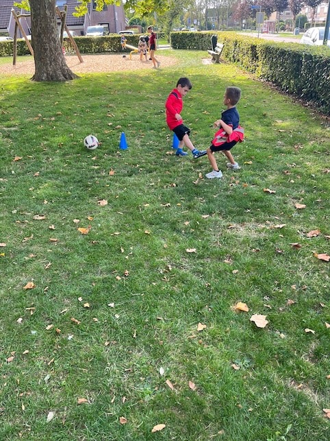 kinderen buiten aan het voetballen